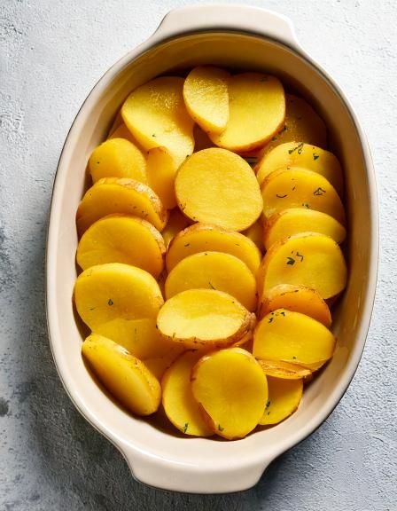 Put raw sliced potatoes in casserole. 3 ingredients later: A bite of pure bliss
